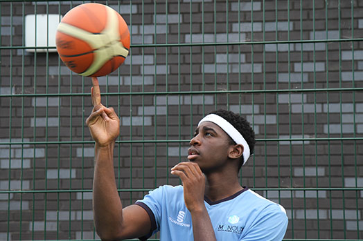 A student taking part in basketball